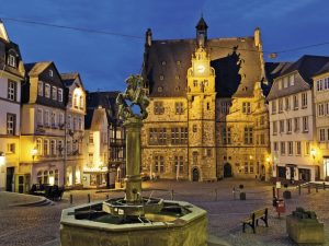 quiet evening in old town Marburg Germany Hesse with fountain and lighted town hall