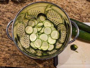 marinated zucchini recipe, sliced zucchini in colander