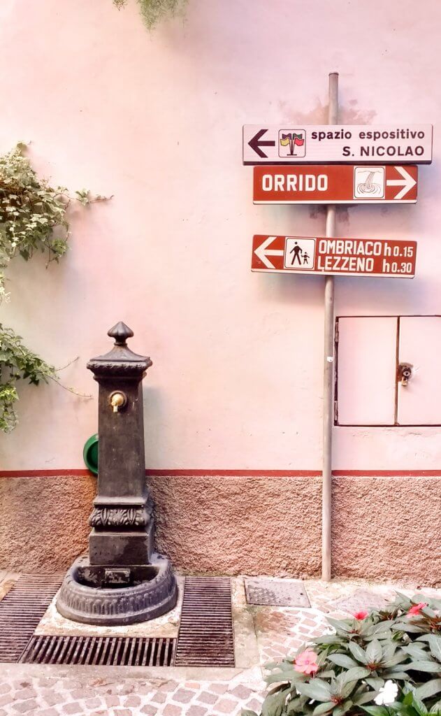 Lake Como Italy Bellano fountain and signs